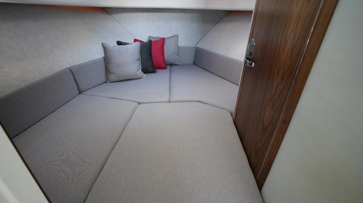 V-berth cabin accommodation for two adults with roof ventilation hatch and portlight